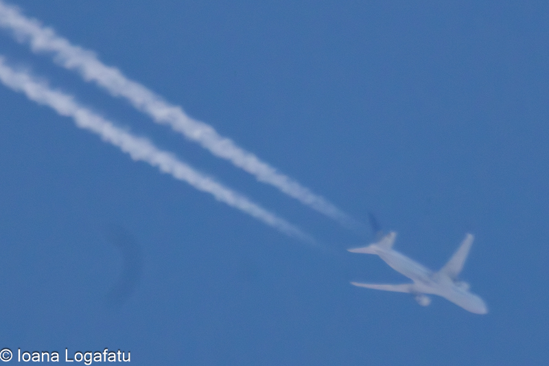 Airplane soaring through the clear blue sky